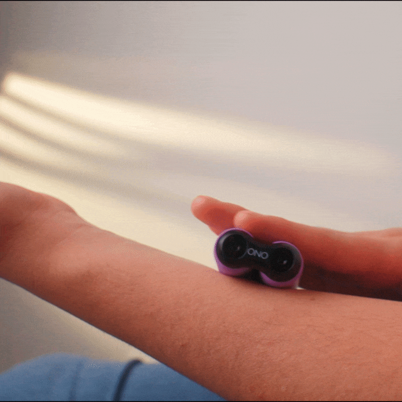 eam_all | ONO Roller lightweight fidget toy in purple held in hand on arm