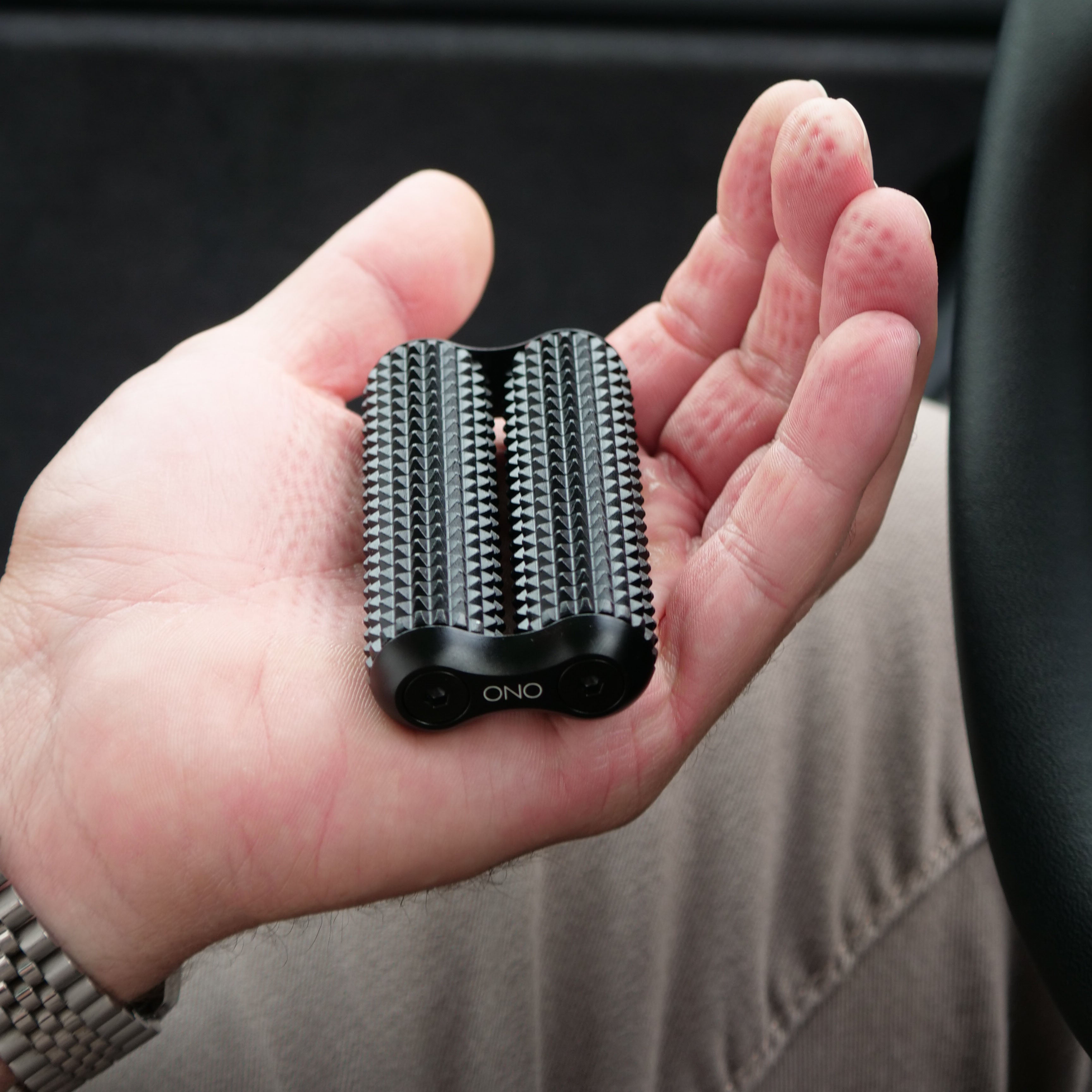 eam_Acupressure_Full | ONO silent fidget roller held in hand, showing textured aluminum surface and black base